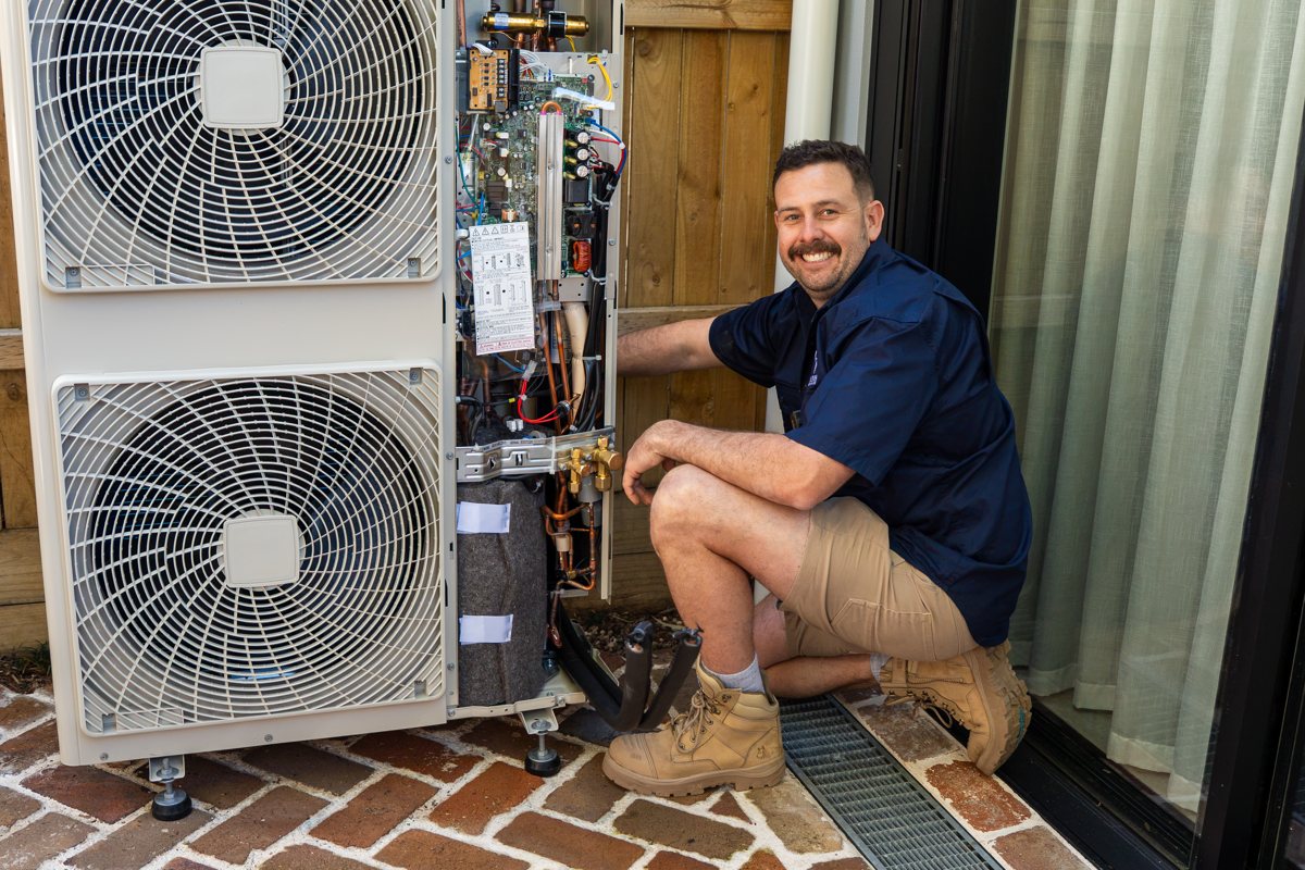 HunterCON technician installing a split system outdoor unit