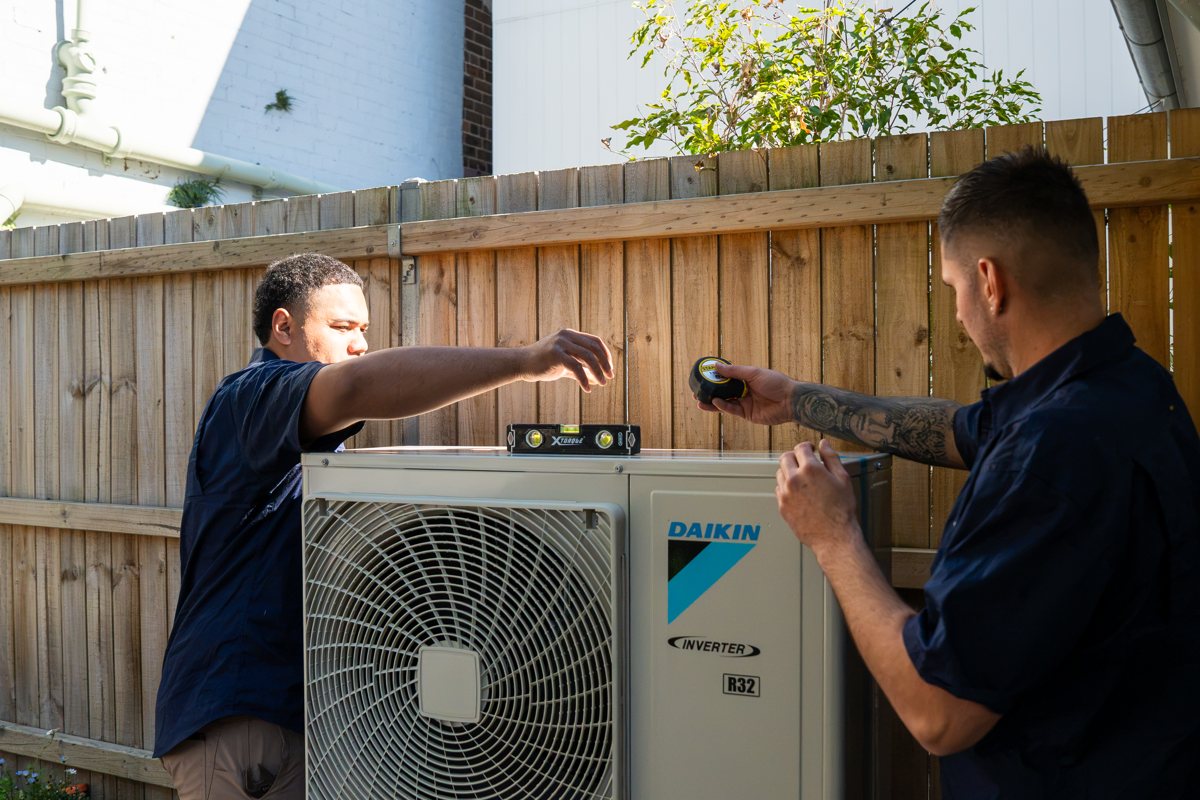 HunterCON technicians installing a Daikin outdoor unit
