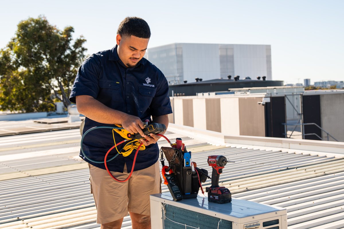 HunterCON technician working on a rooftop unit